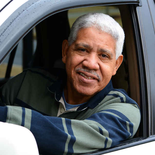 Man smiling from car window